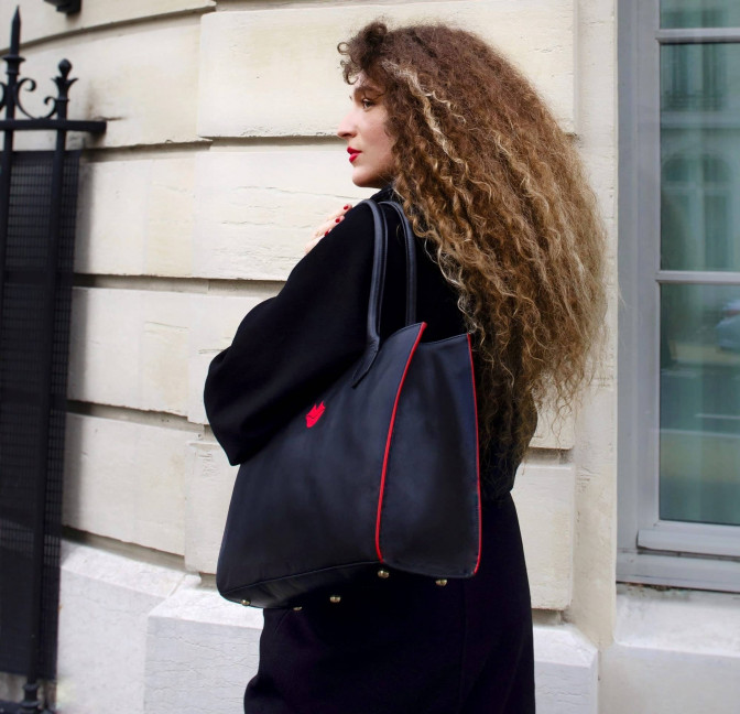 Black PARIS soft leather tote bag with red embroidered mouth and borders, lifestyle view 1 |Gloria Balensi