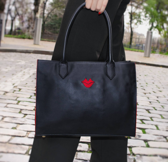 Black PARIS soft leather tote bag with red embroidered mouth and borders, lifestyle view 4 |Gloria Balensi