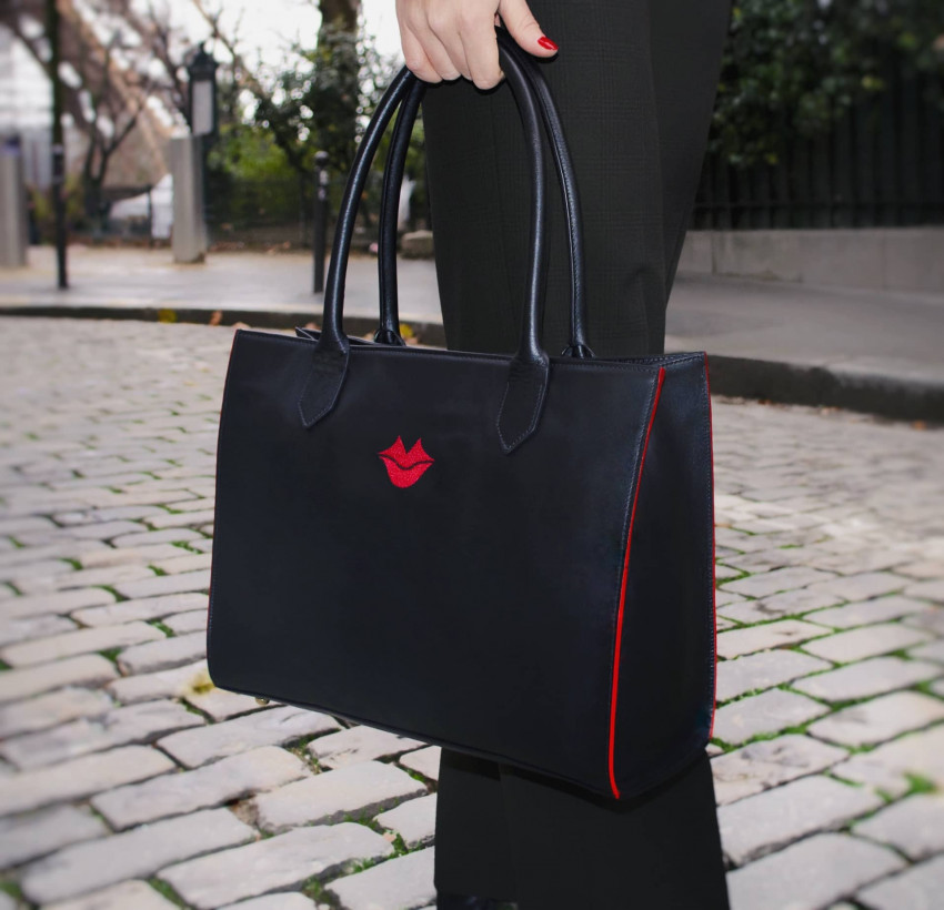 Black PARIS soft leather tote bag with red embroidered mouth and borders, lifestyle view 2 |Gloria Balensi