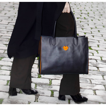 Black PARIS soft leather tote bag with oranges embroidered mouth and borders, lifestyle view 2|Gloria Balensi